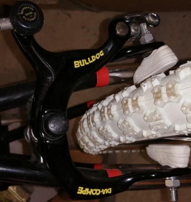 un levier dia compé bulldog modifié; perçage du rivet du réglage de câble en haut pour mettre un weinmann adjuster et  remplacement du serre câble en bas en rivetant un quick release dia compé+patins vans koolstop blanc